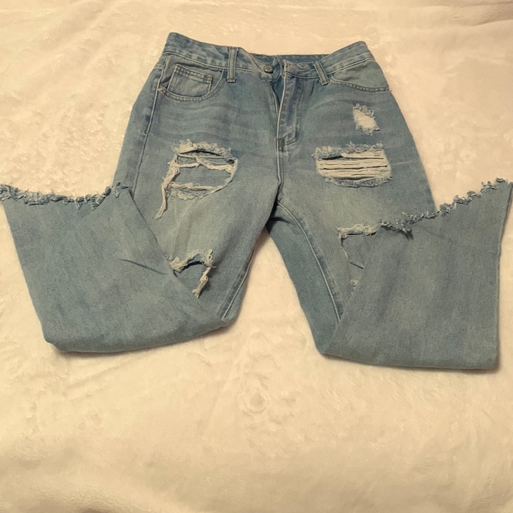 Ripped denim blue jeans